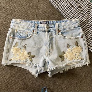 Abercrombie & Fitch Embroidered Floral Detail Distressed Low Rise Jean Shorts.